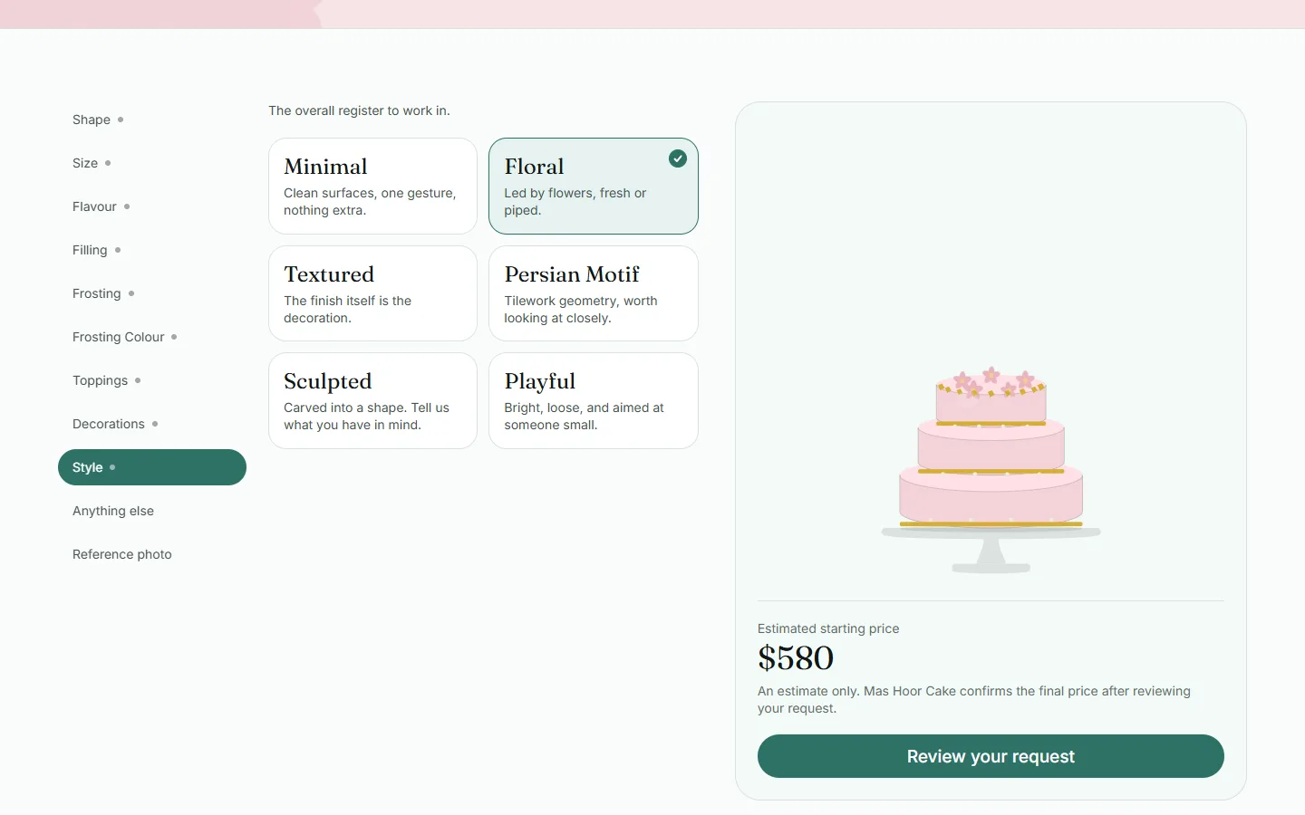 The MasHoorCake Cake Maker with a three-tier pistachio cake in blush pink.